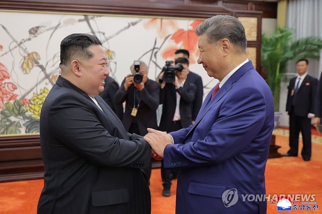 This photo, published by North Korea's Korean Central News Agency on Sept. 5, 2025, shows leader Kim Jong-un (L) holding hands with Chinese President Xi Jinping during their talks the previous day. (For Use Only in the Republic of Korea. No Redistribution) (Yonhap)