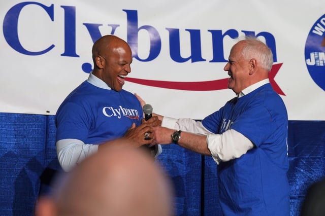 Minnesota Gov. TIm Walz, right, hands the microphone to Maryland Gov. Wes Moore at Rep. Jim Clyburn's World Famous Fish Fry, Friday, May 30, 2025, in Columbia, S.C. (AP Photo/Meg Kinnard)