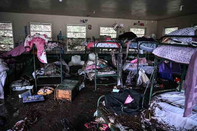 A view inside of a cabin at Camp Mystic, the site of where at least 20 girls went missing after flash flooding in Hunt, Texas, on July 5, 2025. Rescuers were on Saturday searching for more than 20 girls missing from a riverside summer camp in the US state of Texas, after torrential rains caused devastating flooding that killed at least 27 people -- with more rain on the way. "So far, we've evacuated over 850 uninjured people, eight injured people and have recovered 27 deceased fatalities at this time. Of these 27, 18 are adults, nine are children," said Kerr Country Sheriff Larry Leitha on July 5. (Photo by RONALDO SCHEMIDT / AFP) (Photo by RONALDO SCHEMIDT/AFP via Getty Images)          