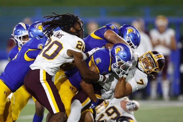 Central Michigan quarterback Angel H Flores (7) is tackled by San Jose State offensive lineman Gafa Faga (50) and San Jose State defensive back Isiah Revis (20) in the fourth quarter during an NCAA football game on Friday, Aug. 29, 2025 in San Jose, Calif. (AP Photo/Lachlan Cunningham)