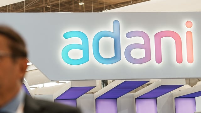 Bengaluru: An official walks past the stall of Adani Defence and Aerospace during the inauguration of Aero India 2023, at Yelahanka air base in Bengaluru, Monday,