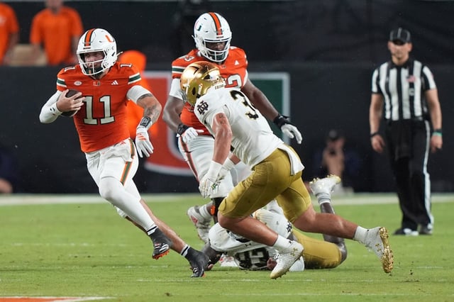 Miami quarterback Carson Beck (11) runs as Notre Dame linebacker Drayk Bowen, right, defends during the first half of UM's win over Notre Dame on Aug. 31 in Miami Gardens. Beck and the Hurricanes host Bethune-Cookman on Saturday. (AP Photo/Lynne Sladky)