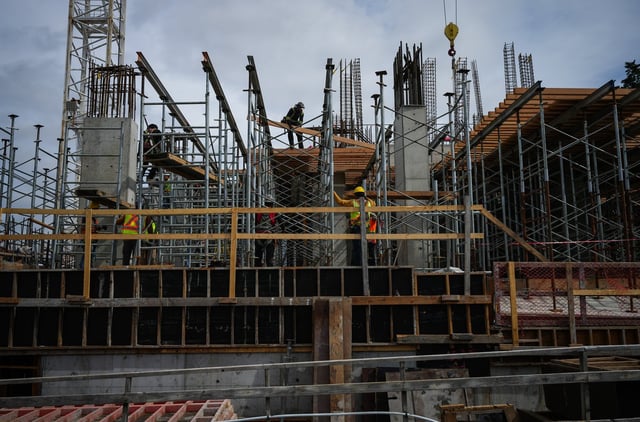 Construction workers work at the site of a condo tower under construction, in Delta, B.C., on Wednesday, July 2, 2025.  THE CANADIAN PRESS/Darryl Dyck