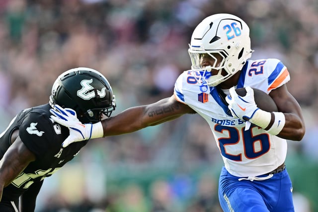 Sire Gaines #26 of the Boise State Broncos stiff-arms Kajuan Banks #13 of the South Florida Bulls in the first half of a game at Raymond James Stadium on August 28, 2025 in Tampa, Florida. (Photo by Julio Aguilar/Getty Images)