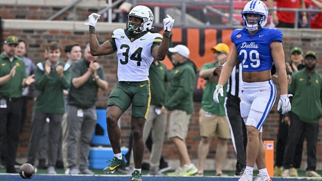Baylor Bears wide receiver Josh Cameron (34) celebrates in front of SMU Mustangs linebacker Brandon Miyazono (29) during the second quarter at Gerald J. Ford Stadium. Mandatory Credit: Jerome Miron-Imagn Images