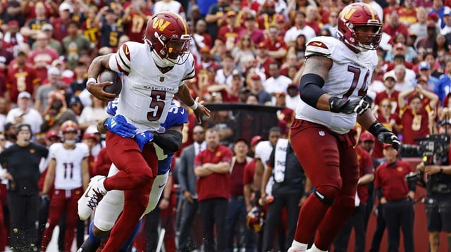 Sep 7, 2025; Landover, Maryland, USA; Washington Commanders quarterback Jayden Daniels (5) runs the ball as New York Giants linebacker Abdul Carter (51) defends during the second quarter at Northwest Stadium. Mandatory Credit: Peter Casey-Imagn Images