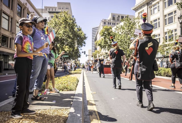 The Arnold Reed family of El Cerrito cheers on the San Francisco Pride Band during the Oakland Pride Parade along Broadway. 