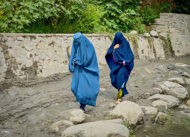 Afghan women in burqas walk towards a safer place after their house was damaged following a deadly magnitude 6 earthquake that struck Afghanistan on Sunday, at Lulam village, in Nurgal district, Kunar province, Afghanistan, September 3. REUTERS/Sayed Hassib