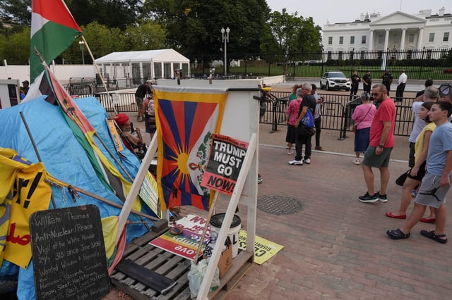 Philipos Melaku-Bello sits on his regular spot at the 44-year-old White House Peace Vigil outside of the White House, after U.S. President Donald Trump ordered its removal, following the deployment of the National Guard and increased presence of federal law enforcement to assist in crime prevention, in Washington, D.C., U.S., September 5, 2025. REUTERS/Leah Millis