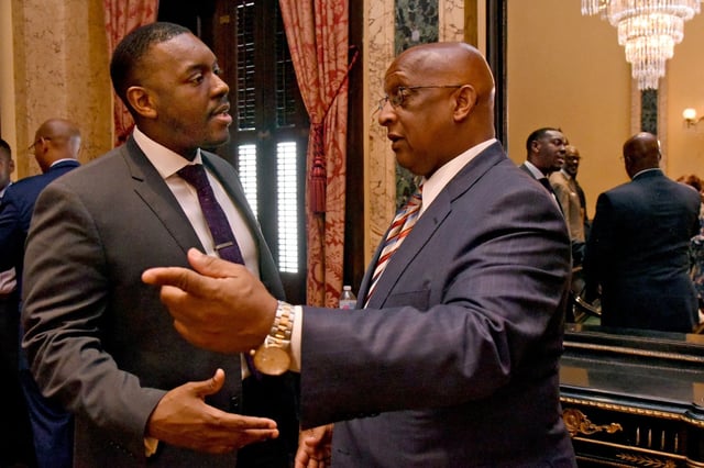 Lester Davis, left, speaks to Mayor Jack Young, right, at City Hall.  Davis, a long-serving aide to Young, recently confirmed that he is taking on an expanded role as both the mayor?s spokesman and top lobbyist.