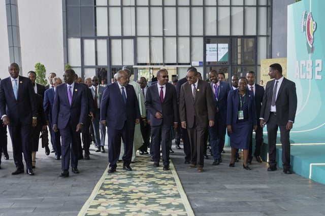 African heads of state and government representatives walk into the plenary hall for the opening of the Second Africa Climate Summit (ACS2) in Addis Ababa, Ethiopia, Monday, Sept. 8, 2025. (AP Photo/Brian Inganga)