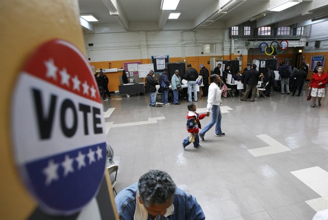 Voters line up to cast their ballots in the Harlem neighborhood of New York, November 4, 2008. REUTERS/Lucas Jackson/File Photo