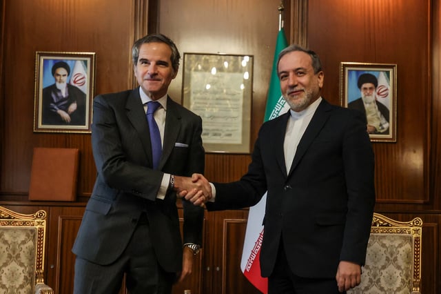 Iran's Foreign Minister Abbas Araghchi (R) shakes hands with International Atomic Energy Agency (IAEA) Director General Rafael Mariano Grossi before a meeting in Tehran on November 14, 2024.