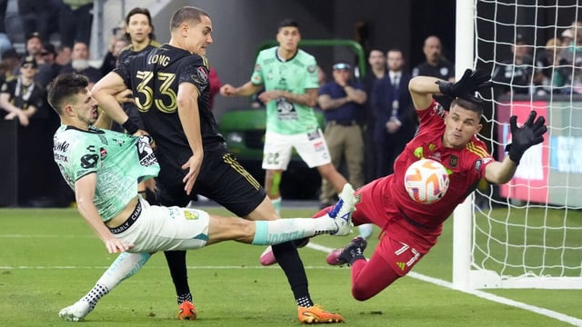 Los Angeles FC goalkeeper John McCarthy (77) leaps to block a shot by León midfielder Lucas Di Yorio.