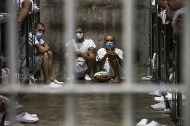 Prisoners look out of their cell at maximum security penitentiary CECOT (Center for the Compulsory Housing of Terrorism) on April 4, 2025 in Tecoluca, San Vicente, El Salvador.