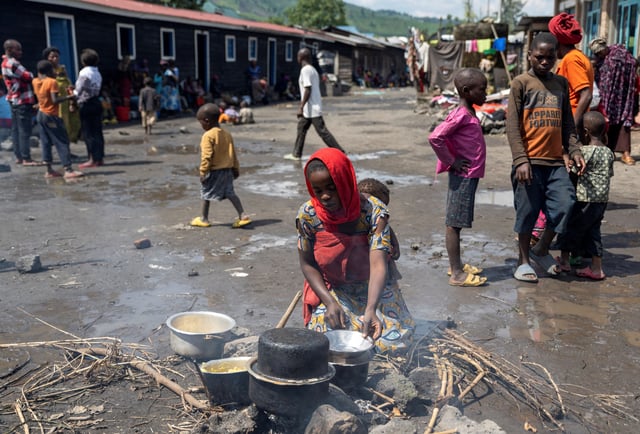 Elisabeth Rebeccah,22, prepares a meal at the Muchacha primary school after recently fleeing from Shonga village following clashes between M23 rebels and the Armed Forces of the Democratic Republic of the Congo (FARDC) in Sake, the Democratic Republic of Congo February 6, 2024. REUTERS/Arlette Bashizi/File Photo