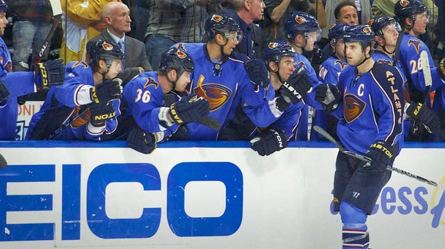 Mar 27, 2011; Atlanta, GA, USA; Atlanta Thrashers left wing Andrew Ladd (C) shakes hands with teammates on the bench after scoring the winning goal in the shootout against the Ottawa Senators at Philips Arena. The Thrashers defeated the Senators 5-4 in a shootout. Mandatory Credit: Dale Zanine-Imagn Images