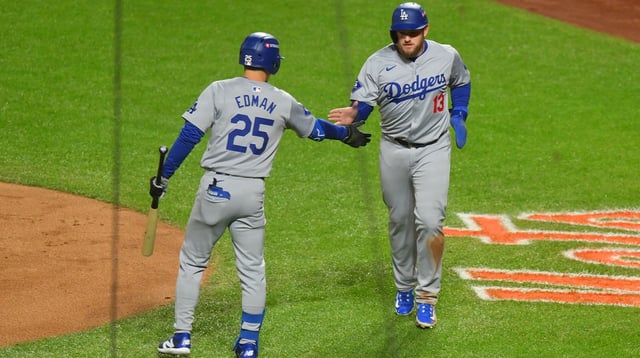 Oct 16, 2024; New York City, New York, USA; Los Angeles Dodgers third base Max Muncy (13) reacts with outfielder Tommy Edman (25) after scroing a run against the New York Mets in the second inning during game three of the NLCS for the 2024 MLB playoffs at Citi Field. Mandatory Credit: John Jones-Imagn Images
