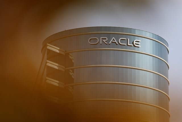 The Oracle logo is displayed on a building at an Oracle campus on March 10, 2025 in Redwood Shores, California.