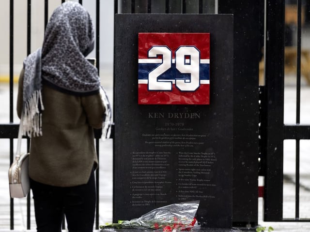 A woman pays her respects and visits the tribute marker of Ken Dryden at the Bell Centre after hearing of his death. Photo taken in Montreal, on Saturday, September 6, 2025. (Allen McInnis/Postmedia Network)