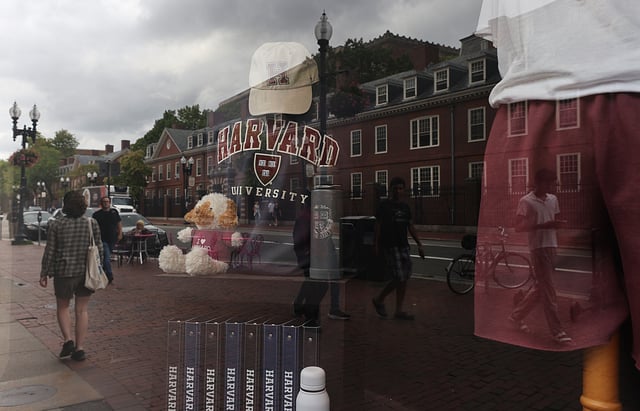 Cambridge, MA, 09/05/2025, Harvard University buildings are reflected in a shop across the street. Suzanne Kreiter/Globe staff