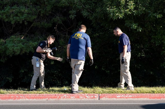 Members of the FBI forensics team work at a wooded area, near the reported possible escape route of the shooter of U.S. right-wing activist, commentator, Charlie Kirk, an ally of U.S. President Donald Trump, who was fatally shot during an event at Utah Valley University, in Orem, Utah, U.S. September 11, 2025.  REUTERS/Cheney Orr     TPX IMAGES OF THE DAY