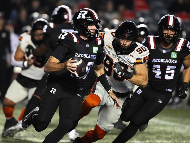 Redblacks quarterback Dustin Crum is chased by B.C. Lions defensive lineman Mathieu Betts (90) as he runs with the ball during CFL action in Ottawa on Sept. 5.