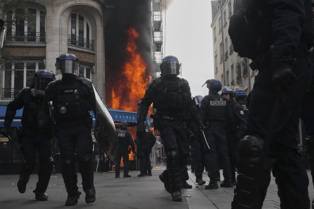 Riot police officers take position in front of a burning restaurant during the Bloquons Tout (Block Everything) protest movement in Paris, France, Wednesday on September 10, 2025.