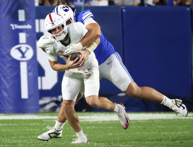 BYU defensive tackle Keanu Tanuvasa, right, sacks Stanford quarterback Ben Gulbranson during the first half of an NCAA college football game Saturday Sept. 6, 2025, in Provo, Utah. (AP Photo/Jeffrey D. Allred)