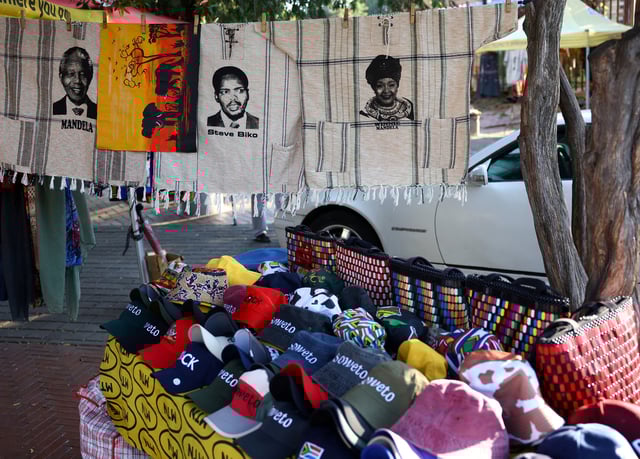 Souvenirs with faces of the late anti-apartheid activists and politicians of South Africa including Nelson Mandela, Steve Bantu Biko and Winnie Madikizela Mandela are displayed at a makeshift stall on Vilakazi Street, the only street in the world which was home to two Nobel Peace Prize winners, President Nelson Mandela and Archbishop Desmond Tutu, in Soweto, South Africa, April 22, 2024. REUTERS/Siphiwe Sibeko/File Photo