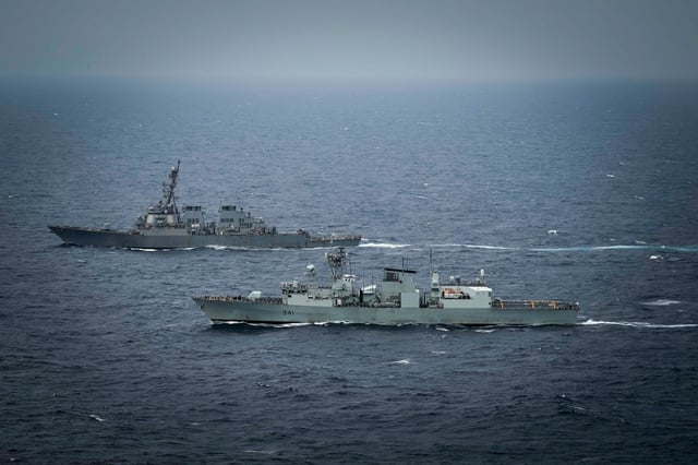 The U.S. Navy Arleigh Burke-class guided missile destroyer USS Higgins and Canadian navy Halifax-class frigate HMCS Ottawa conduct maneuvers in international waters in the South China Sea on January, 11 2025.