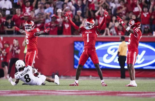 Houston defensive back Latrell McCutchin Sr., center, reacts between defensive backs Jordan Allen, left, and defensive back Will James after breaking up a pass intended for Colorado wide receiver Joseph Williams (8) during the second half of a Big 12 Conference college football game in Houston, Friday, Sept. 12, 2025.