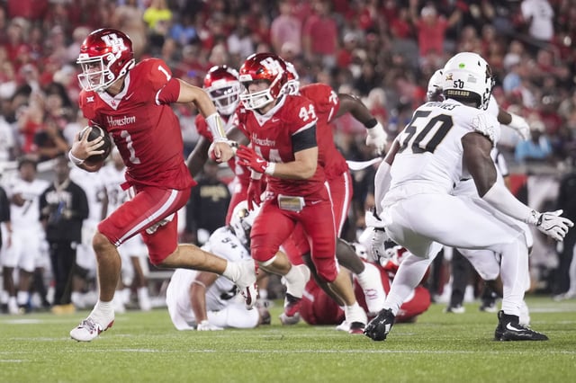 Houston quarterback Conner Weigman (1) runs for a 7-yard touchdown during the second half of a Big 12 Conference college football game in Houston, Friday, Sept. 12, 2025.