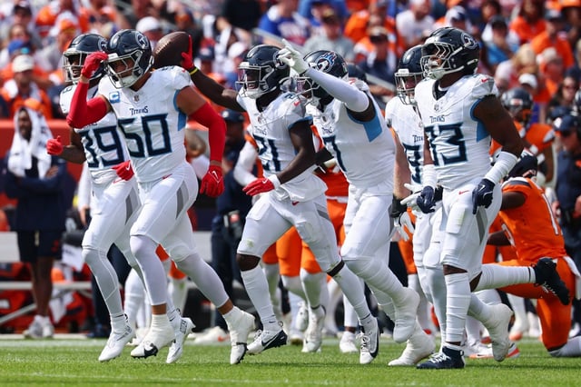 Roger McCreary (21) celebrates his interception with his Tennessee Titans teammates during the first quarter against the Denver Broncos on Sunday, Sept. 7, 2025, in Denver. (Photo by Tyler Schank/Getty Images)
