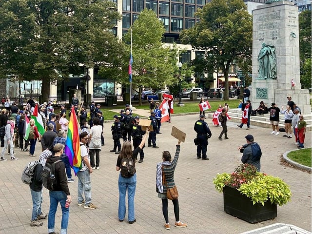  Anti-immigration protestors face counter-demonstrators on the Grand Parade in Halifax on Saturday. – GLENN MacDONALD