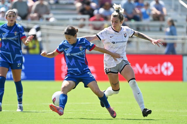 Sep 13, 2025; Cary, North Carolina, USA;  North Carolina Courage midfielder Manaka Matsukubo (34) steals the ball from Angel City FC Midfielder Macey Hodge (8) during the first half at First Horizon Stadium at WakeMed Soccer Park. Mandatory Credit: Zachary Taft-Imagn Images