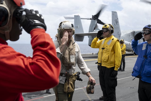 Secretary of War Pete Hegseth salutes US service members while on board the USS Iwo Jima, Sept. 8, 2025. (Photograph by US Navy Petty Officer 2nd Class Aiko Bongolan)