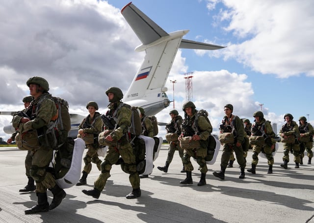 Russian paratroopers walk before boarding Ilyushin Il-76 transport planes as they take part in the military exercises "Zapad-2021" staged by the armed forces of Russia and Belarus at an aerodrome in Kaliningrad Region, Russia. September 13, 2021. (REUTERS/Vitaly Nevar)