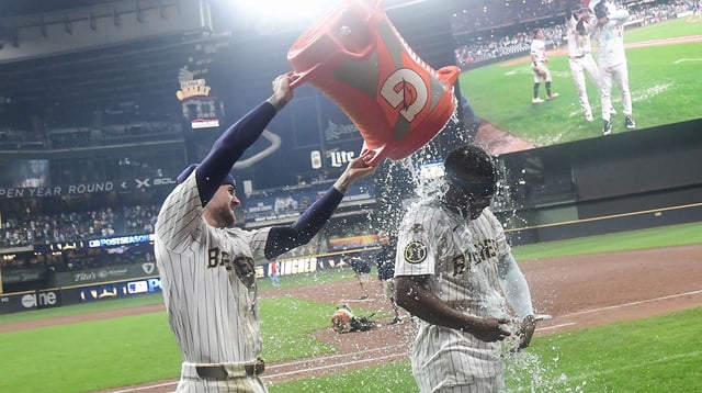 Sep 13, 2025; Milwaukee, Wisconsin, USA; Milwaukee Brewers second baseman Andruw Monasterio (14) is dunked by second baseman Brice Turang (2) after beating the St. Louis Cardinals in the tenth inning at American Family Field. Mandatory Credit: Benny Sieu-Imagn Images