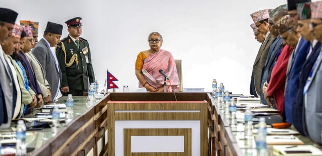 La nouvelle Première ministre du Népal Sushila Karki (C) lors d'une minute de silence observée en mémoire des victimes des émeutes meurtrières à Katmandou qui ont fait au moins 72 morts, le 14 septembre 2025 à Katmandou
