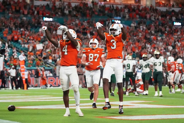Miami Hurricanes running back Mark Fletcher Jr. (4) celebrates with Miami Hurricanes wide receiver Joshua Moore (3) after scoring a touchdown during the second half of an NCAA college football game against South Florida, Saturday, Sept. 13, 2025, in Miami Gardens, Fla. (AP Photo/Rebecca Blackwell)