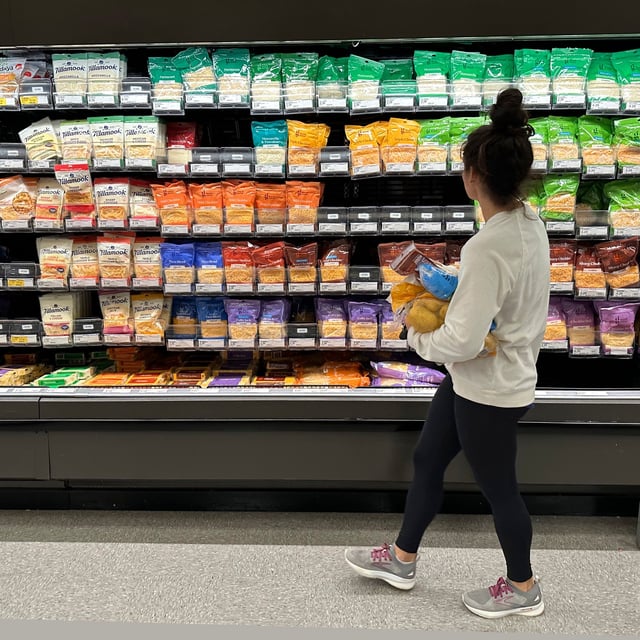 File - A shopper peruses cheese offerings at a Target store on Oct. 4, 2023, in Sheridan, Colo. Inflation is easing slightly, but grocery prices are still high. (AP Photo/David Zalubowski, File)