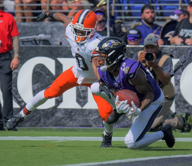 Baltimore Ravens wide receiver DeAndre Hopkins catches a pass from quarterback Lamar Jackson in front of Cleveland Browns cornerback Greg Newsome II, dropping to the turf one foot from the goal line, setting up a field goal during the third quarter of Baltimore’s 41-17 NFL home opener win. (Karl Merton Ferron/Staff)