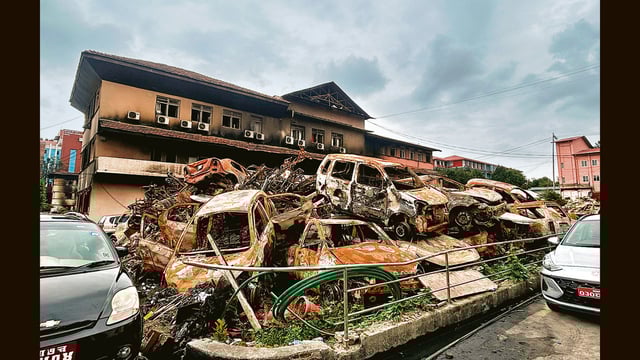 Charred vehicles dumped outside the damaged building of Nepal Supreme Court. (HT Photo)