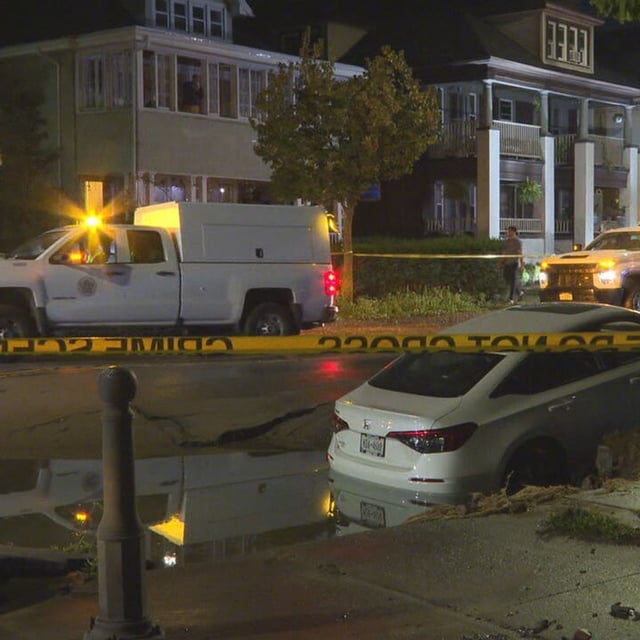 A car is stuck in a sinkhole due to a water main break on Monroe Avenue at Shepard Street,, Saturday night, Sept. 13, 2025. (Photo by Jess Kszos/WHAM)