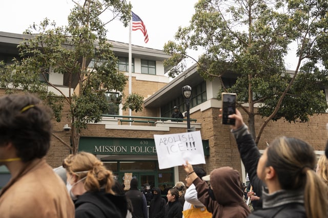 Protesters hold a sign reading "Abolish Ice" in front of a police station as they march in response to federal immigration operations in the Mission District of San Francisco, California on June 9, 2025.