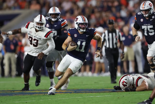 Sep 6, 2025; Auburn, Alabama, USA; Auburn Tigers quarterback Jackson Arnold (11) scrambles during the second quarter against the Ball State Cardinals at Jordan-Hare Stadium. Mandatory Credit: John Reed-Imagn Images