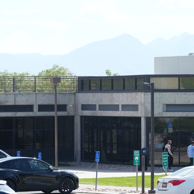 Law enforcement stands at the top of the Losee Center, where the alleged gunman used to escape from the roof after shooting and killing Turning Point USA CEO and co-founder Charlie Kirk, at Utah Valley University, Friday, Sept. 12, 2025, in Orem, Utah. (AP Photo/Lindsey Wasson)