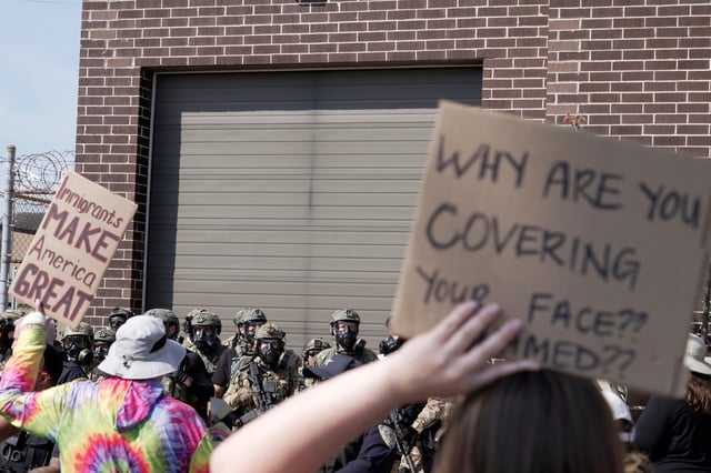 People protest outside of an immigration facility guarded by federal agents Friday, Sept. 12, 2025, in in Broadview, Ill. (AP Photo/Laura Bargfeld)