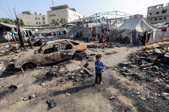 A boy looks on at the site of an strike on an area sheltering displaced people at Al-Aqsa hospital in central Gaza on October 15, 2024.